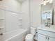 Modern bathroom featuring a shower-tub combo and a vanity with a mirror at 95 Great Smoky Pl, Lillington, NC 27546