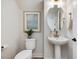 Elegant powder room featuring a pedestal sink, oval mirror, and neutral decor at 95 Great Smoky Pl, Lillington, NC 27546