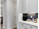 Close-up of a coffee bar with marble countertops and a dark herringbone backsplash at 95 Great Smoky Pl, Lillington, NC 27546