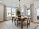 Bright dining area with a wooden table, six chairs, and large windows at 95 Great Smoky Pl, Lillington, NC 27546