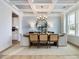 Dining room with modern chandelier, decorative wallpaper and view into the kitchen at 95 Great Smoky Pl, Lillington, NC 27546