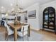 Modern dining space with stylish light fixture and adjacent kitchen area at 95 Great Smoky Pl, Lillington, NC 27546