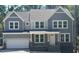 Beautiful two-story home with gray siding, stone accents, and an attached two-car garage at 95 Great Smoky Pl, Lillington, NC 27546