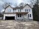 New construction home featuring covered entry, two-car garage and situated on a large lot at 95 Great Smoky Pl, Lillington, NC 27546