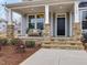 Inviting front porch with stone accents and a comfortable bench at 95 Great Smoky Pl, Lillington, NC 27546
