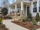 Charming front porch with stone pillars and a landscaped yard at 95 Great Smoky Pl, Lillington, NC 27546