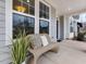 Cozy front porch with a wicker bench and decorative pillows at 95 Great Smoky Pl, Lillington, NC 27546