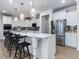 Spacious white kitchen with a large island and modern pendant lighting at 95 Great Smoky Pl, Lillington, NC 27546