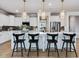 Stylish kitchen island with seating and views into the adjacent spaces at 95 Great Smoky Pl, Lillington, NC 27546