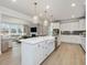 Bright, modern kitchen with stainless appliances and view to living area at 95 Great Smoky Pl, Lillington, NC 27546
