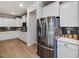 Modern kitchen featuring stainless steel appliances and white cabinets with contrasting backsplash at 95 Great Smoky Pl, Lillington, NC 27546