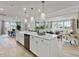 Open kitchen with a large island, stainless steel appliances, and view of the living area at 95 Great Smoky Pl, Lillington, NC 27546