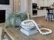 Close-up of a coffee table in the living room, with decorative items and a view of the kitchen at 95 Great Smoky Pl, Lillington, NC 27546
