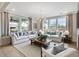 Spacious living room featuring large windows, comfortable sofas, and a stylish coffee table at 95 Great Smoky Pl, Lillington, NC 27546