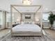 Bright bedroom with four poster bed and natural light from two windows at 95 Great Smoky Pl, Lillington, NC 27546