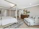 Large primary bedroom featuring ample space, light hardwood floors, and comfortable sitting area at 95 Great Smoky Pl, Lillington, NC 27546