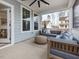 Covered patio with comfortable seating and an outdoor ceiling fan at 95 Great Smoky Pl, Lillington, NC 27546