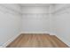 Spacious walk-in closet with wood floors and ample shelving for organized storage at 95 Great Smoky Pl, Lillington, NC 27546