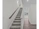 Inviting entryway features a staircase with wooden handrail and a view into the carpeted living space at 1124 Solace Way, Rolesville, NC 27571