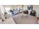 Bright, open-concept living room with modern furniture, flowing into the kitchen and dining area at 1156 Solace Way, Rolesville, NC 27571