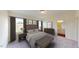 Serene main bedroom featuring neutral tones, large windows, and en-suite bathroom access at 1156 Solace Way, Rolesville, NC 27571