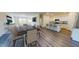 Open floor plan with a dining area, living area, and kitchen with white cabinets and a granite countertop at 1157 Solace Way, Rolesville, NC 27571
