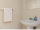 Compact bathroom with a pedestal sink, mirror, and towel rack at 124 Friar Ln, Carrboro, NC 27510