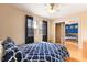 Comfortable bedroom with hardwood floors, ceiling fan, and large closet with mirror doors at 124 Friar Ln, Carrboro, NC 27510