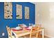 Cozy dining area with blue accent wall, table set for four, and bright, natural light at 124 Friar Ln, Carrboro, NC 27510