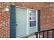 Inviting entrance with a green door and shutters on a brick home at 124 Friar Ln, Carrboro, NC 27510