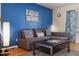 Cozy living room featuring a comfortable sofa, a modern coffee table, and a blue accent wall at 124 Friar Ln, Carrboro, NC 27510