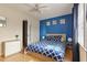 Comfortable bedroom with a blue accent wall, full-sized bed, and bright, natural light at 124 Friar Ln, Carrboro, NC 27510