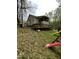 View of the backyard with a wooden deck and playful slide at 128 Madeline Ct, Youngsville, NC 27596