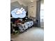 bedroom with mountain mural, window, and bed with gaming-themed bedding at 128 Madeline Ct, Youngsville, NC 27596