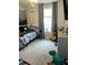 Spacious bedroom featuring a guitar, a mountain mural, and a window at 128 Madeline Ct, Youngsville, NC 27596