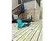 Wooden back deck with a fire pit, a set of stairs, chairs, and a view of the lush forest at 128 Madeline Ct, Youngsville, NC 27596