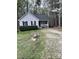 Quaint one-story house featuring a cozy front porch and lush green shrubbery at 128 Madeline Ct, Youngsville, NC 27596