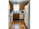 Well-lit kitchen with oak cabinetry and white appliances at 128 Madeline Ct, Youngsville, NC 27596