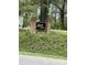 Brick community sign reading 'Mill Creek' surrounded by natural landscaping at 128 Madeline Ct, Youngsville, NC 27596