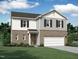 Charming two-story home featuring a brick facade, gray siding, and a two-car garage at 132 Oat Grain Ct, Clayton, NC 27520