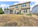 Large backyard showing the home's screened porch, patio, and lush lawn at 156 Greenhurst Cir, Holly Springs, NC 27540