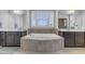 Beautiful bathroom features a tub with tile surround, dual sinks, and many windows at 156 Greenhurst Cir, Holly Springs, NC 27540