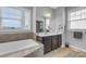 Bathroom featuring a large soaking tub, vanity with storage, and tile flooring at 156 Greenhurst Cir, Holly Springs, NC 27540