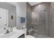 Modern bathroom featuring gray tiling and a frameless glass shower with built-in bench at 156 Greenhurst Cir, Holly Springs, NC 27540
