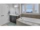 Bathroom with a large soaking tub, vanity with great storage, and natural light at 156 Greenhurst Cir, Holly Springs, NC 27540