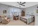 Comfortable bedroom with ceiling fan, ensuite, desk, and a beautifully decorated queen-size bed at 156 Greenhurst Cir, Holly Springs, NC 27540