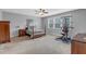 Bright bedroom showcasing a four-poster bed, natural light, and exercise equipment at 156 Greenhurst Cir, Holly Springs, NC 27540