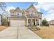 Beautiful two-story home boasts stone accents, a well-maintained lawn, and a spacious driveway at 156 Greenhurst Cir, Holly Springs, NC 27540