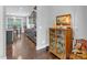 Hallway with hardwood floors leads to a well-equipped kitchen and dining area at 156 Greenhurst Cir, Holly Springs, NC 27540