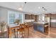Open-concept kitchen features a large island with granite counters and a stainless steel refrigerator at 156 Greenhurst Cir, Holly Springs, NC 27540